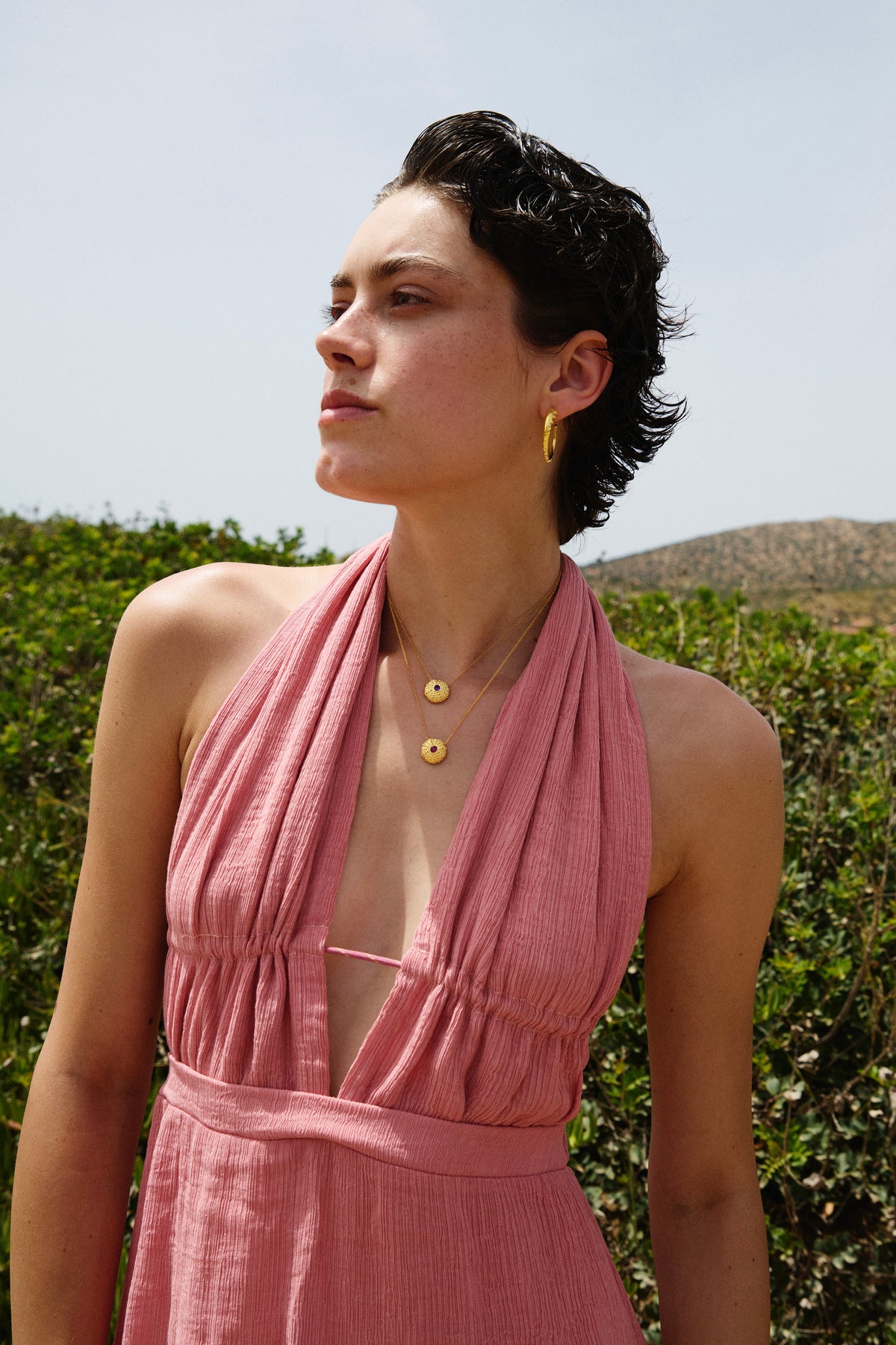 Feggeri Ahinos gemstone necklaces in gold vermeil layered over a pink dress