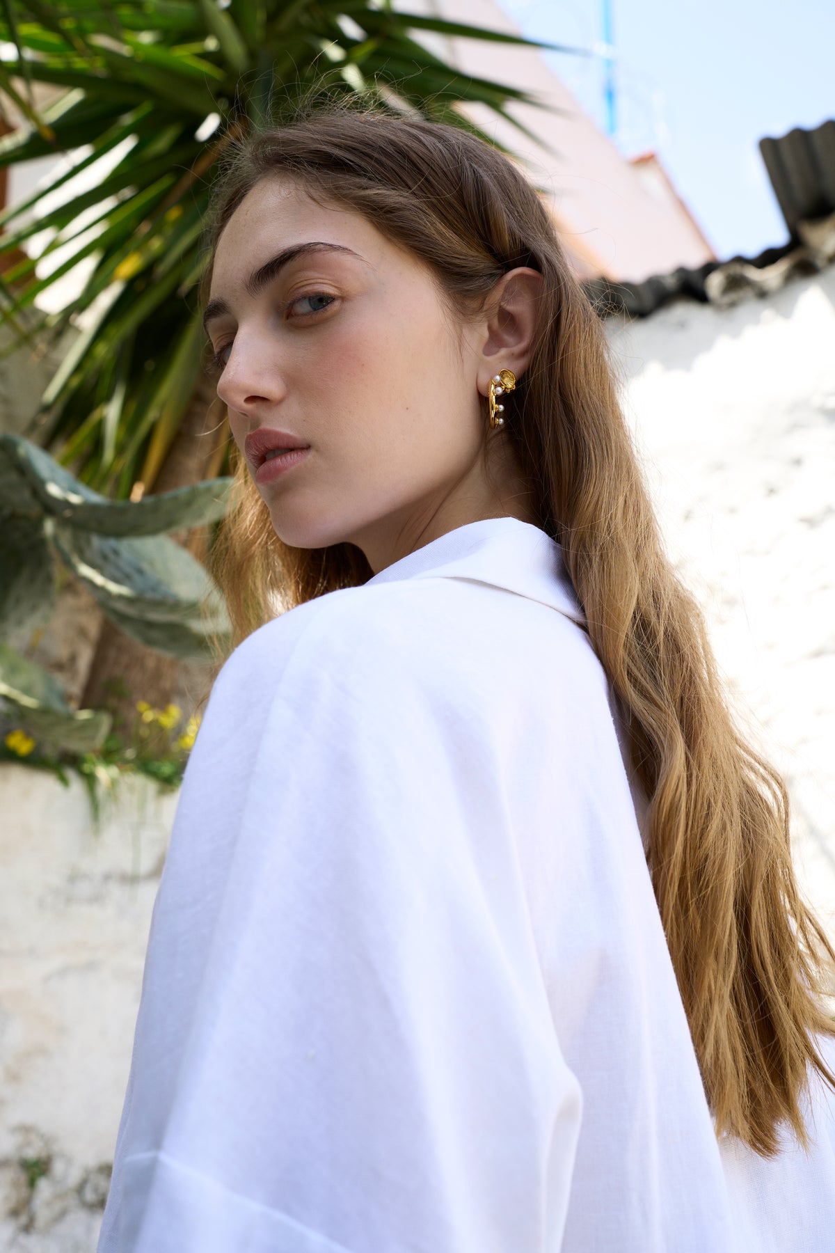 Feggeri Ahinos Gold Vermeil Triad Stud Earrings worn by a model