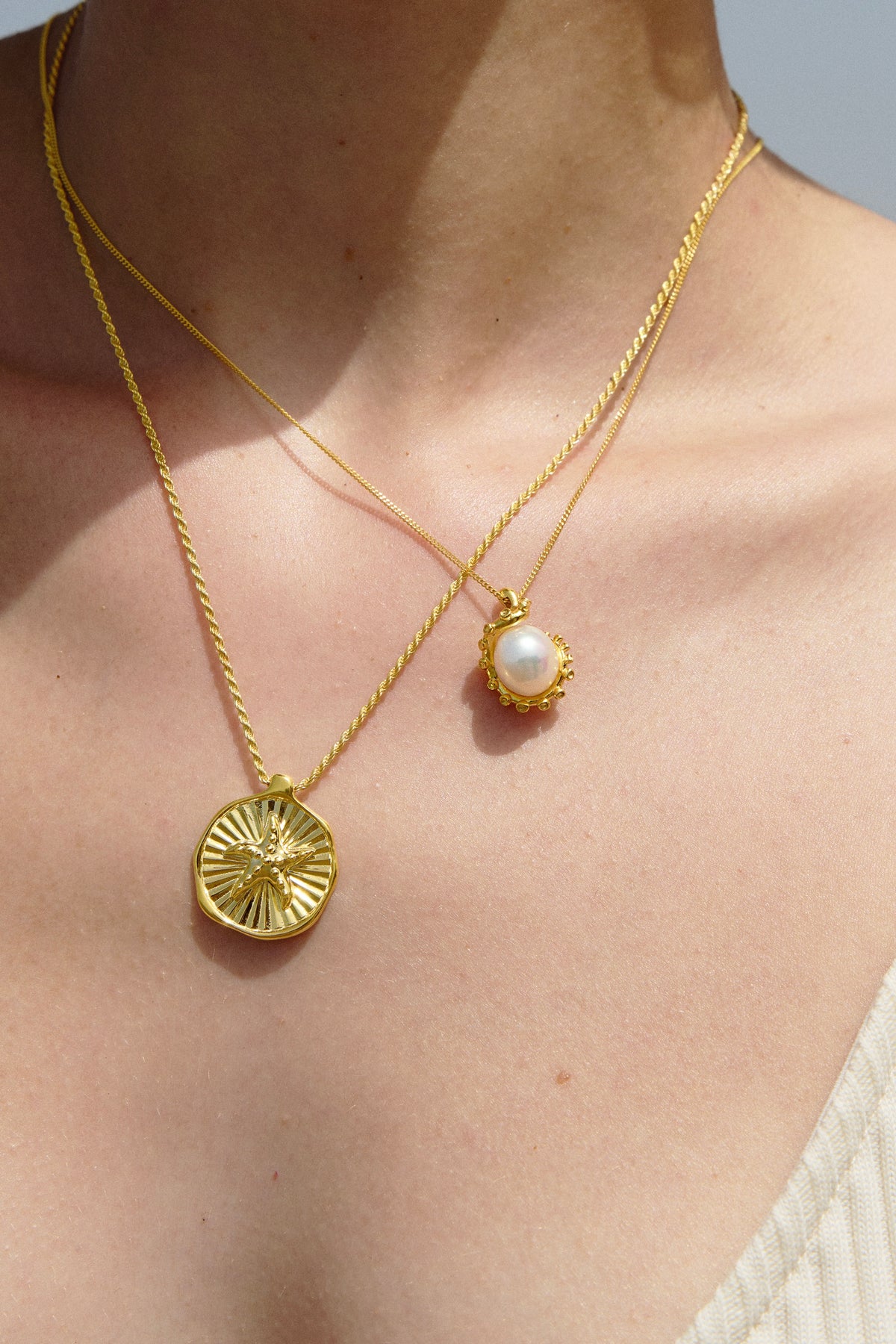 Feggeri Astra starfish and Okto freshwater pearl necklaces in gold vermeil worn together