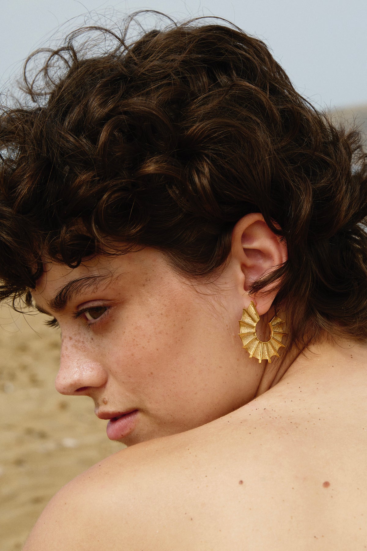 Feggeri Ippos Gold Vermeil Fin Statement Earrings worn by a model