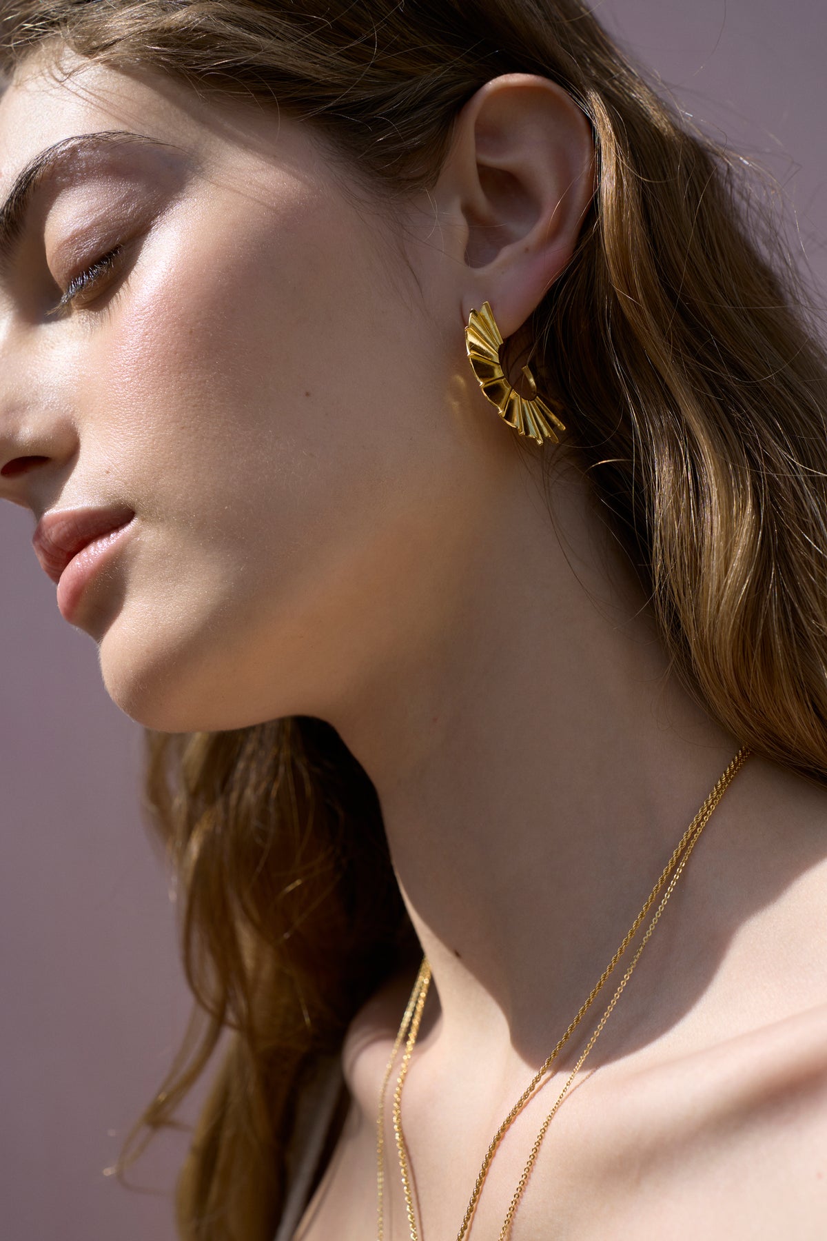 Feggeri Ippos Gold Vermeil Fin Statement Earrings worn by a model