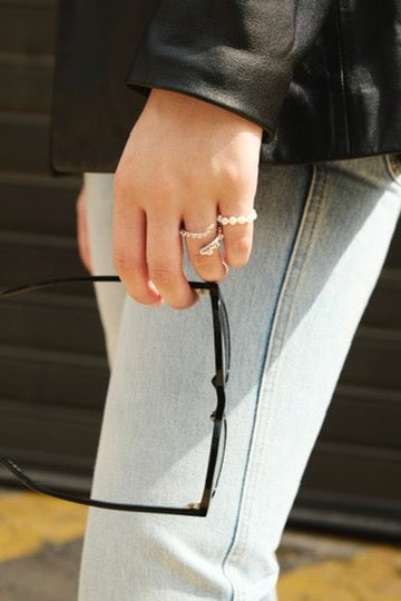 Feggeri Aphrodite pearl ring worn beside sunglasses