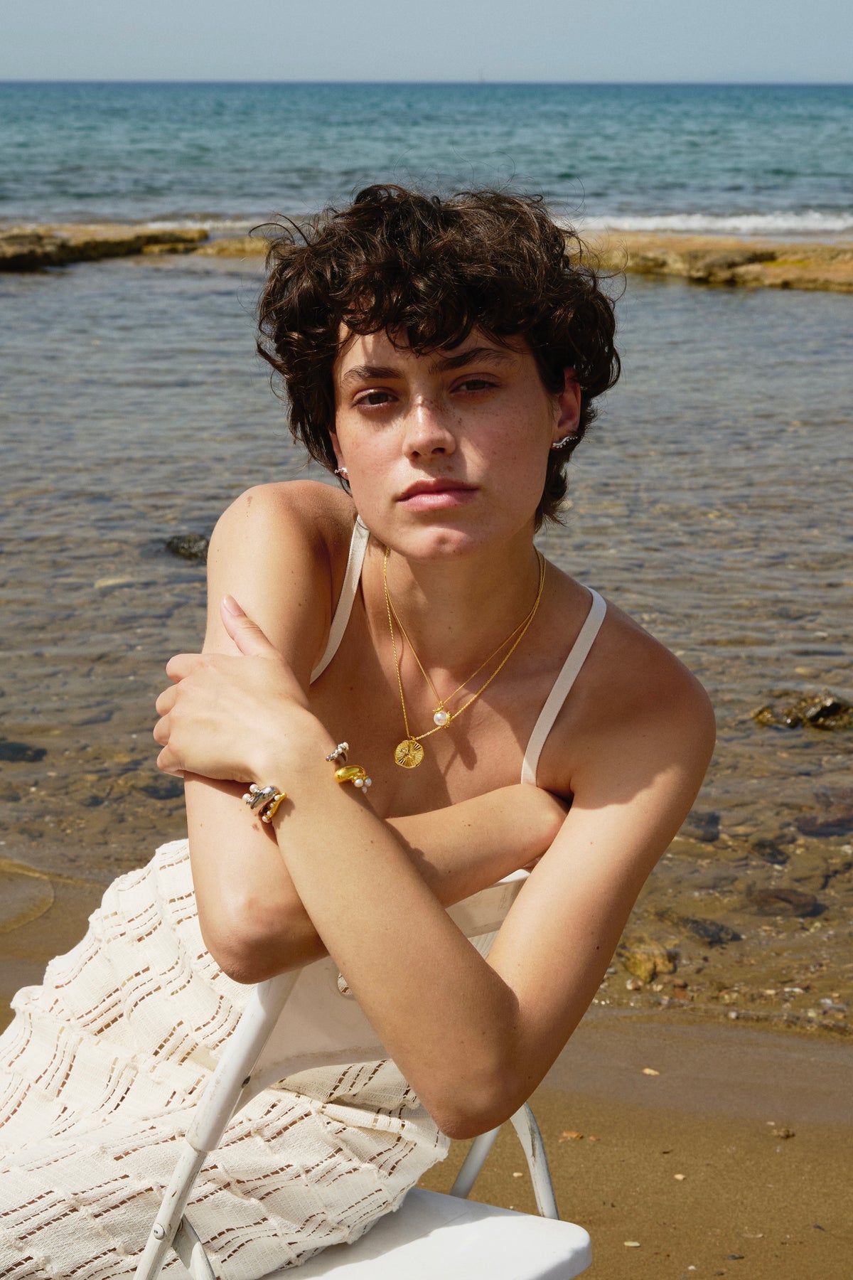 Feggeri Feggeri sculptural jewellery worn by a model at the beach