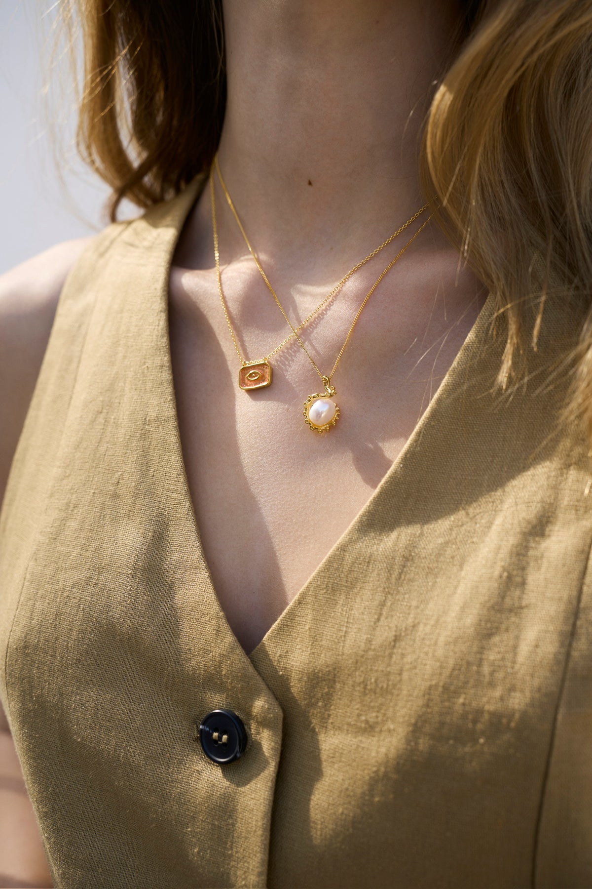 Feggeri Okto freshwater pearl necklace layered with a rectangular Mati pendant