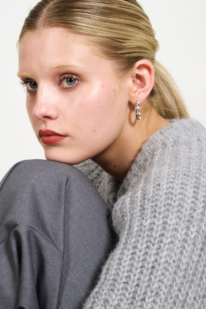 Feggeri Okto Sterling Silver Pearl Hoop Earrings worn by a model