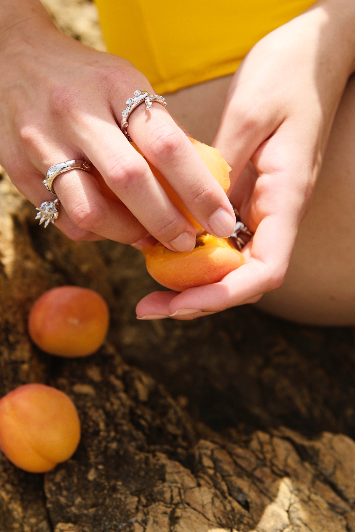 Feggeri Okto octopus ring in sterling silver worn beside apricots