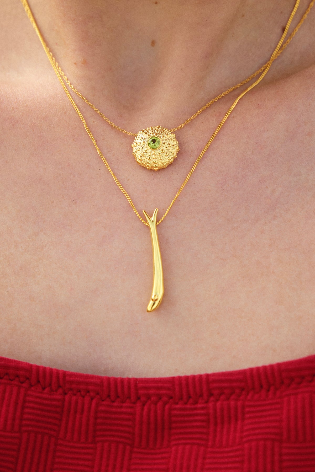 Feggeri Psari fish and Ahinos peridot necklaces in gold vermeil worn together