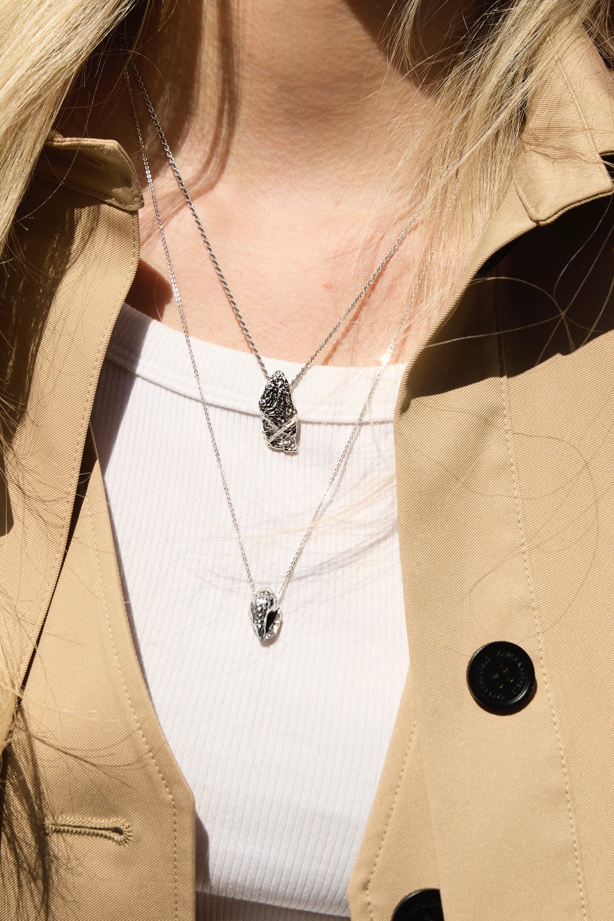Feggeri Conch Shell and Shell Fragment necklaces in sterling silver worn with a trench coat